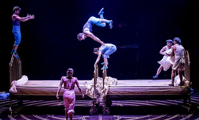 Circus performers of Cirque du Soleil performing on bouncing beds