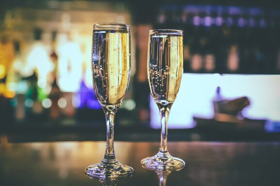 A close up of two glasses of champagne on the bar at Madame Tussauds Champagne Bar