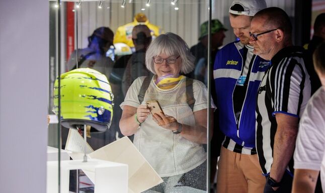 A woman looking at an exhibit at the Silverstone Museum
