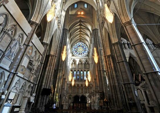 The interior of Westminster Abbey showcasing the grand columns and stained glass windows