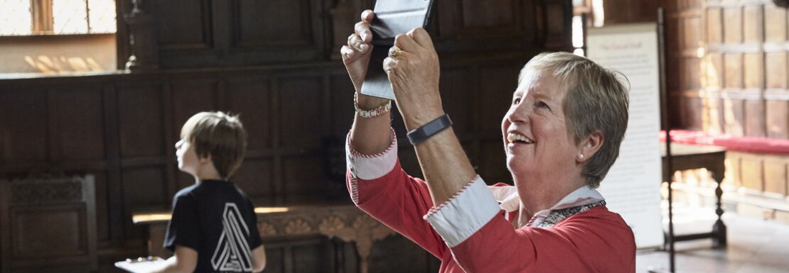 Visitors at Speke Hall in Liverpool take photos of the National Trust site