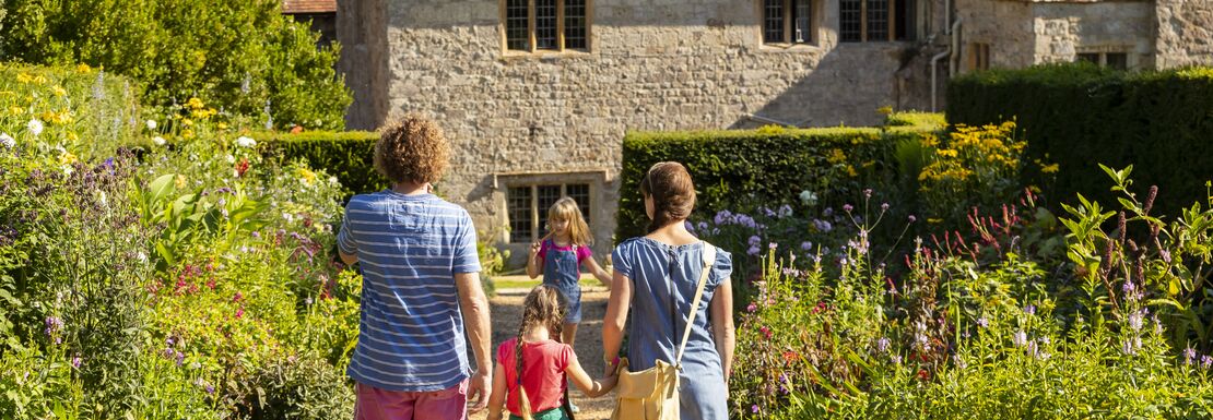 A family of visitors in the garden at Mottistone in the Isle of Wight