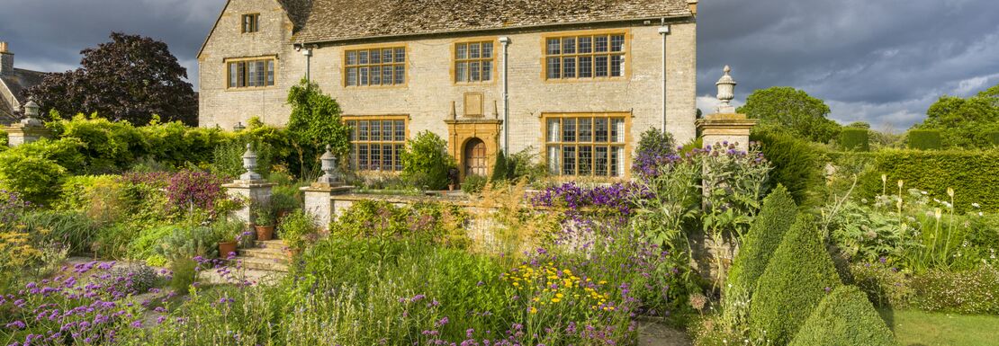 The West Garden at Lytes Cary Manor in Somerset on a warm but cloudy day