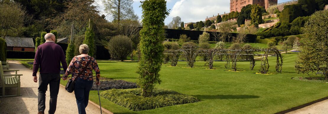 Visitors walking around the garden in spring at Powis Castle in Wales