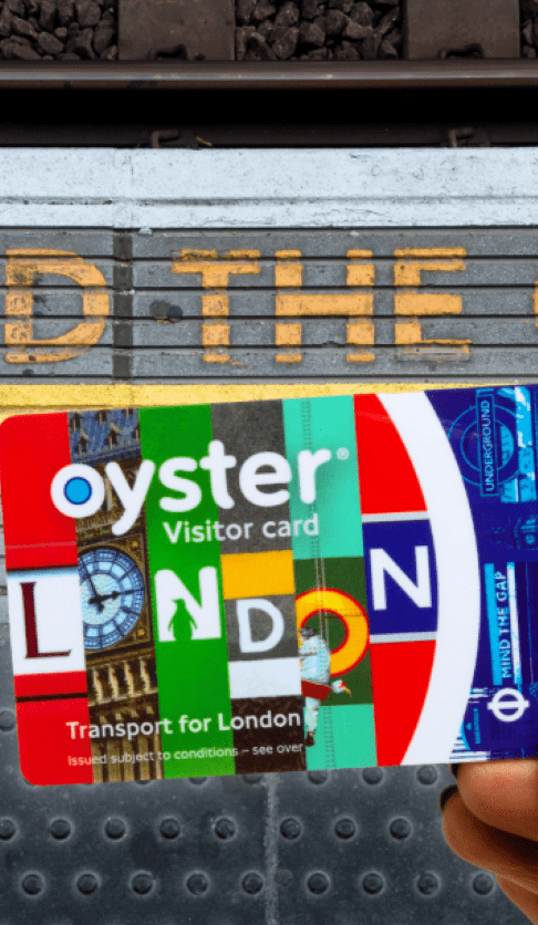 The Visitor Oyster card held at a station platform