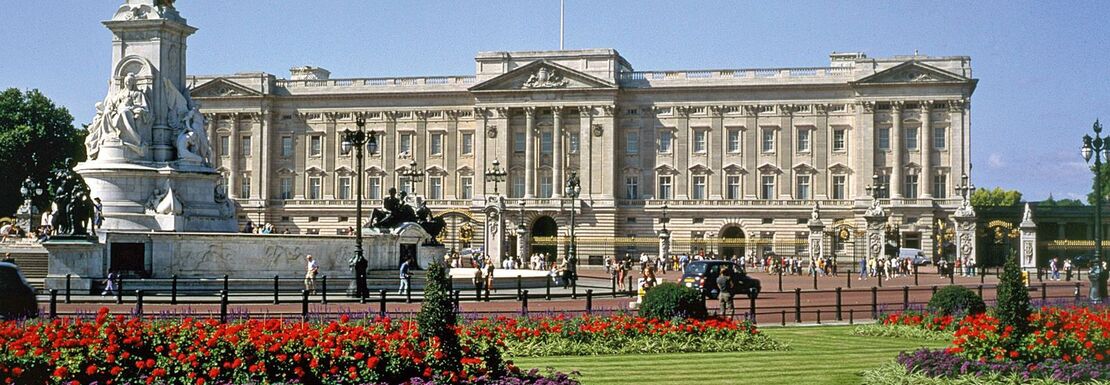 Buckingham Palace with the garden in the foreground on a sunny day