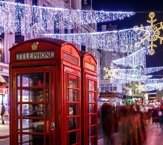 Red telephone boxes illuminated by Christmas lights
