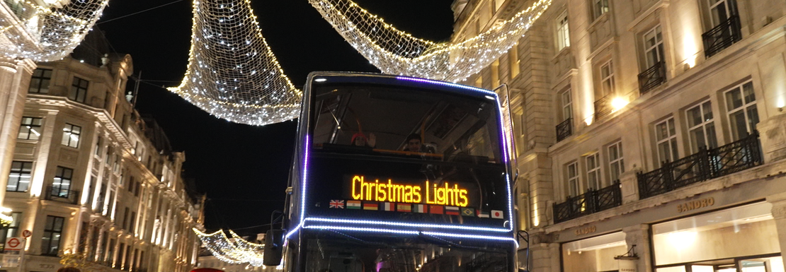 A Christmas Lights tour bus on an illuminated street