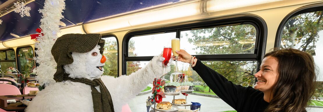 Snowman character having tea time