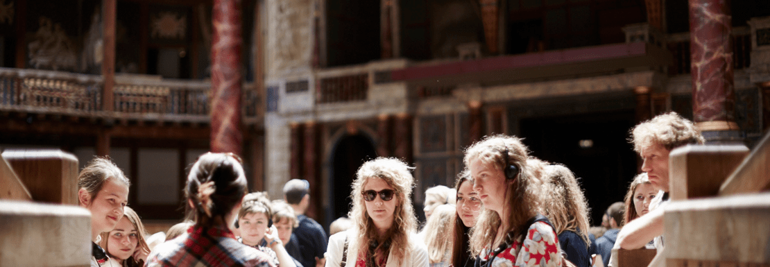 A tour group being guided around Shakespeare's Globe