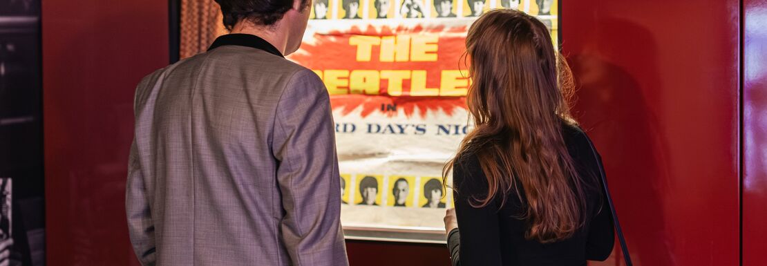 Couple looking at exhibit at Beatles Story