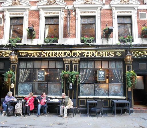 People sat outside The Sherlock Holmes pub in London