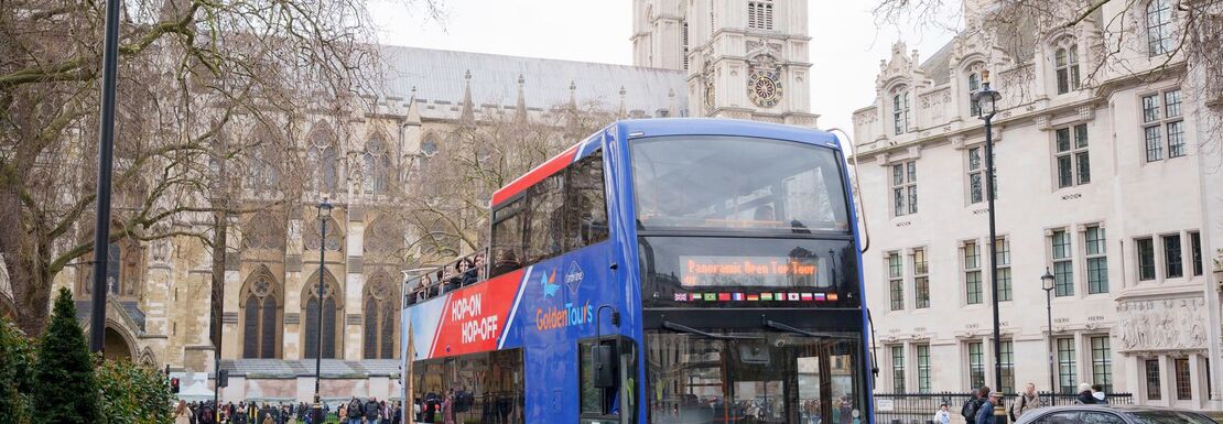 Red and blue open bus in a London street