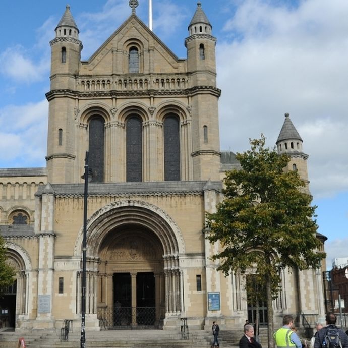 a_group_of_tourists_listening_to_their_guide_during_best_of_belfast_walking_tour