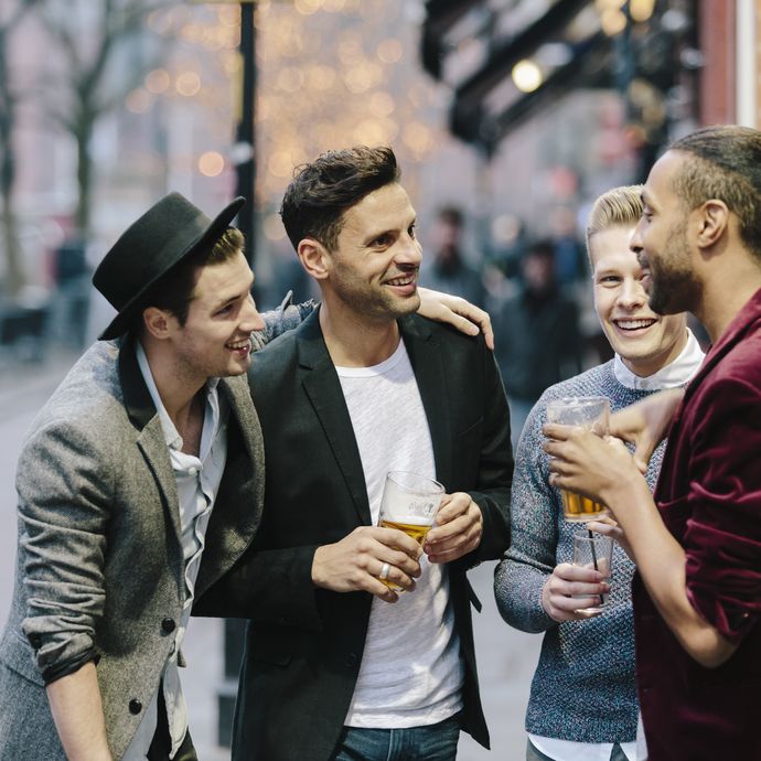 Gay couples standing together and having drinks