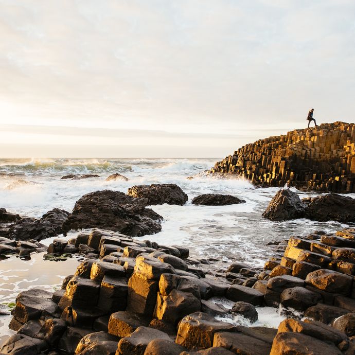 Rock formations coming out of sea. Crashing waves. Dusk