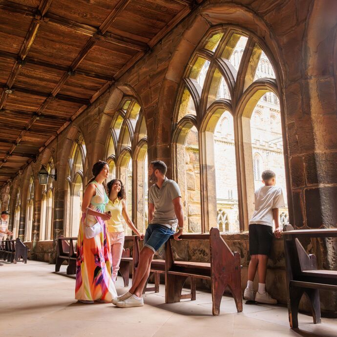 A family walking inside the cloisters of Durham Cathedral